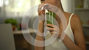 Girl smells green smoothie, feels disgust, tasteless but healthy diet, closeup