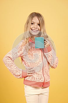 Girl smile with blue cup on orange background