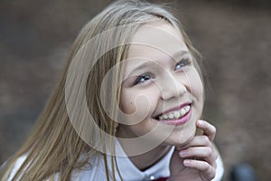 Girl smile with cute face, beauty. Little child smiling with long blond hair, hairstyle outdoor. Baby beauty, hair and