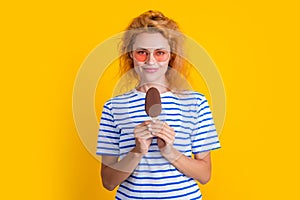 girl smile with icelolly ice cream isolated on yellow. girl with icelolly ice cream in studio. photo