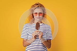 girl smile with icelolly ice cream isolated on yellow. girl with icelolly ice cream in studio. photo