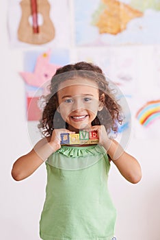 Girl, smile and learn with blocks in portrait, child development and growth with letters. Female person, kid and abc or