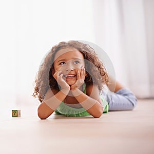 Girl, smile and learning alphabet with blocks in home, child development and growth with letters. Female person, kid and