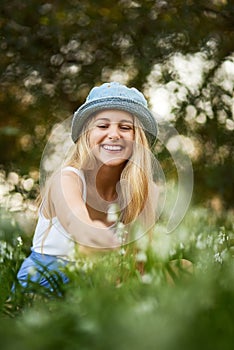 Girl, smile and outdoor, nature and flowers, park and grass lawn for plants, spring and garden. Field, happy and explore