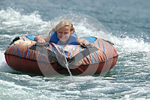 Girl Smiles Aboard Water Tube photo