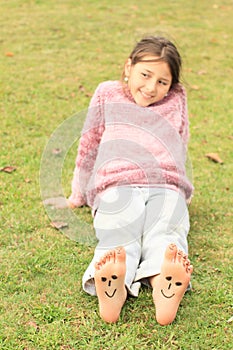 Girl with smileys on toes and soles