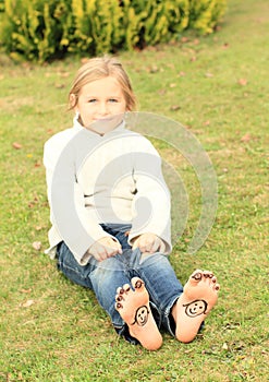 Girl with smileys on toes and soles