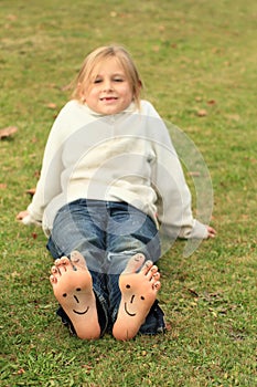 Girl with smileys on toes and soles photo