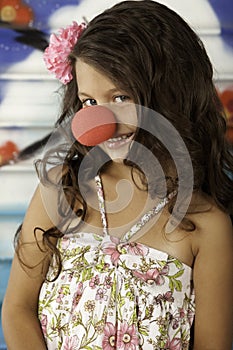 Girl smiling with clown nose