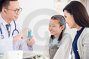 Girl smiling while doctor explain inhaler using method