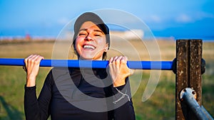 girl smiling doing pullups