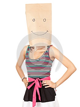 Girl in smiling ecological paper bag on head