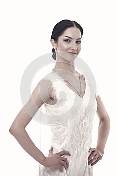 Girl on smiling face dressed in luxury dress with fur posing with posture. Dancer of ballroom dance looks gorgeous