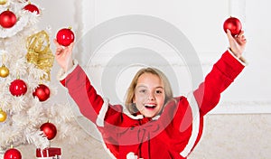 Girl smiling face hold balls ornaments white interior background. Let kid decorate christmas tree. Favorite part