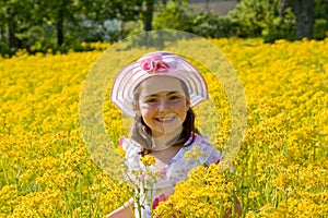 Girl Smiling in Front of Flowers