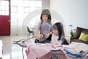 girl smiling happily as she doing the ironing at home