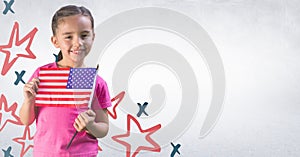 Girl smiling and holding american flag against white wall with hand drawn star pattern
