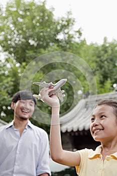 Girl Smiling and Playing with Airplane