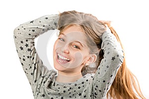 Girl smiling and playing with her hair