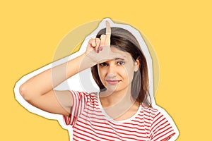 Girl smiling showing loser sign on forehead. emotional girl isolated on Magazine collage style with trendy color