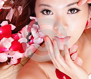 Girl smiling and touch face with red rose