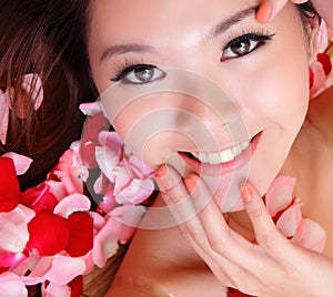 Girl smiling and touch face with red rose