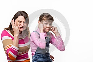 Girl sneezes, child plugged ears, isolated on white background photo