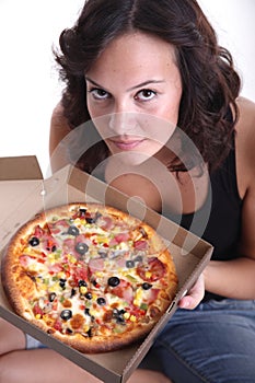 Girl sniffing pizza photo