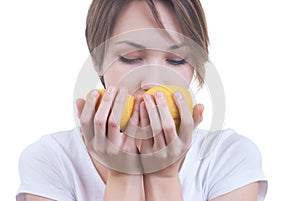 Girl sniffing two parts of lemon