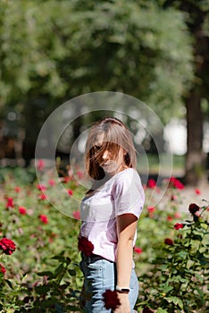 Girl sniffs a red flower.teenager girl smelling roses