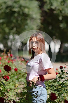 Girl sniffs a red flower.teenager girl smelling roses