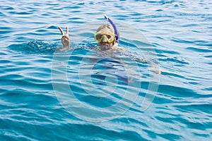 Girl snorkeling mask portrait looking at camera summer travel vacation life style time concept picture relaxation in Red sea