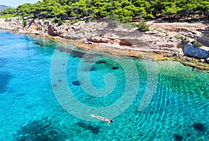 Girl snorkeling in the turquoise waters of Moni Island