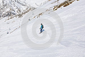 Girl snowboarder on the background of mountains in the winter se