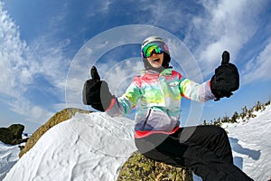 Girl snowboarder enjoys the ski resort