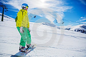 Girl snowboarder enjoys the winter ski resort.