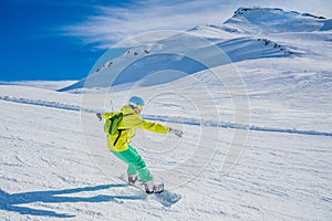 Girl snowboarder enjoys the winter ski resort.