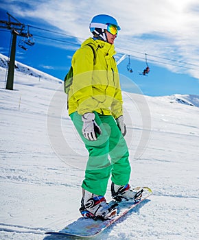 Girl snowboarder enjoys the winter ski resort.