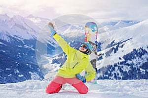 Girl snowboarder enjoys the winter ski resort.