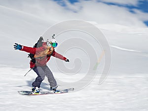 Girl snowboarder goes quickly down the slope and shouts