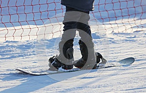 The girl is snowboarding in the snow