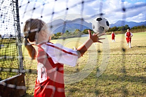 Girl, soccer and ball with goal keeper for save, match or game from scoring point on outdoor field. Team of football