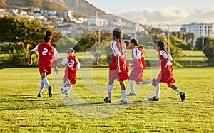 Girl, soccer and fitness team in field sports playing fun game together in training for competition outdoors. Group of