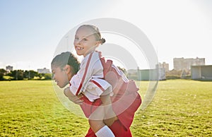 Girl soccer and team friends on field enjoying match game leisure break with fun piggyback ride. Happy, young and