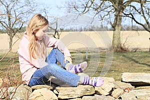 Girl in socks on wall