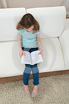 Girl On Sofa Reading Book