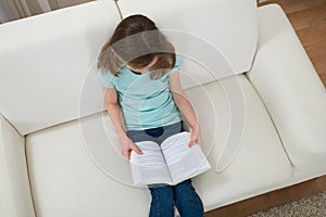 Girl On Sofa Reading Book