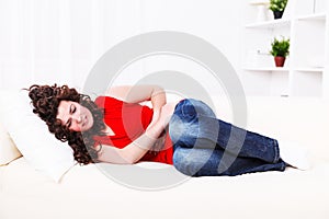 Girl on the sofa with stomach ache