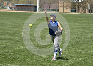 Girl softball pitcher warming up before a game