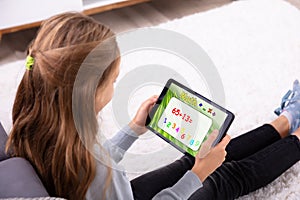 Girl Solving Math On Digital Tablet